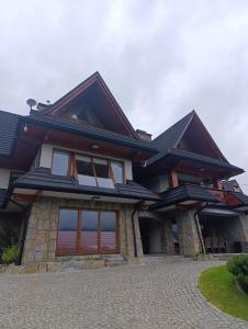 a house with a gambrel roof at Secret Residence with Sauna & Private Pool in Kościelisko