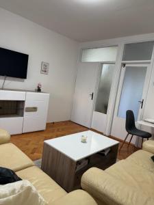 a living room with a couch and a coffee table at Emama Residence Mostar in Mostar