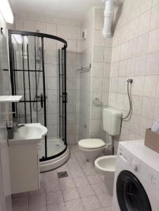 a bathroom with a shower and a toilet and a sink at Emama Residence Mostar in Mostar +12 photos