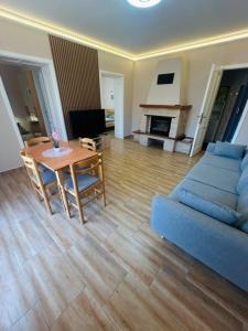a living room with a blue couch and a table at Csuszka vendégház in Tiszafüred
