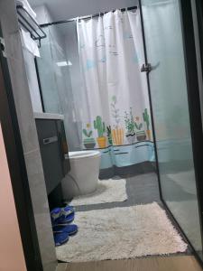 a bathroom with a shower and a toilet with plants at Haven 2 lustic in Nairobi