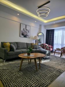 a living room with a couch and a table at Haven 2 lustic in Nairobi