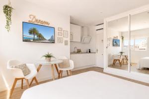 a bedroom with a table and chairs and a kitchen at New Central Studio Torremolinos in Torremolinos