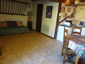 a bedroom with a bed and a table in a room at GITE Au Moulié in Blousson-Sérian