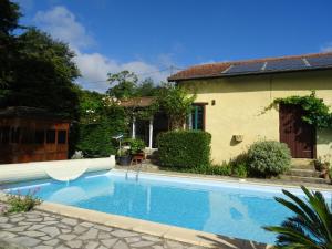 a swimming pool in front of a house at GITE Au Moulié in Blousson-Sérian