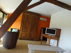 a room with a desk and a computer on a table at GITE Au Moulié in Blousson-Sérian