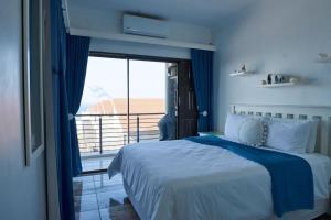 a bedroom with a bed and a large window at Luxury Ocean View Escape with Private Rooftop -Sancta Maria in Kingsborough +30 photos