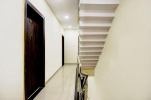 a hallway with stairs and a door at SPOT ON Hotel Shree Ji in Indore