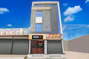 a building with a qeyes sign in front of it at SPOT ON Hotel Shree Ji in Indore +20 photos