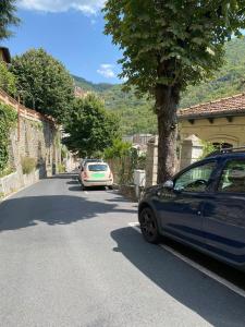 a car parked next to a tree on a street at Casa Vacanza Pigna in Pigna