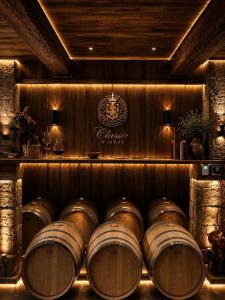 a row of barrels in a wine cellar at HOTEL GUGLUX &WINE CELLAR in Telavi