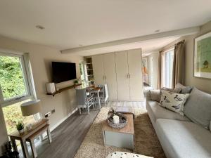 a living room with a couch and a table at The Willow Luxury Countryside Retreat in Stone