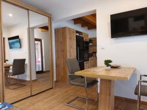 a kitchen and dining room with a table and chairs at Village Premium Apartment by Český Krumlov Adults Only in Střížov