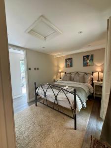 a bedroom with a bed in a room with a window at The Willow Luxury Countryside Retreat in Stone