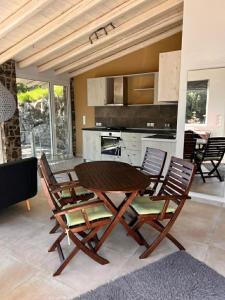 a dining room with a table and chairs in a kitchen at Ellia Mirtiotissa Rooms in Glyfada