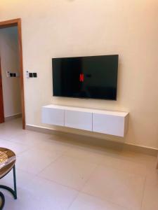 a large flat screen tv on a wall at Cozynest nungwi in Nungwi