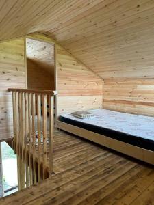 a large wooden room with a bed in a room at კოტეჯი in Ts'ikhisdziri