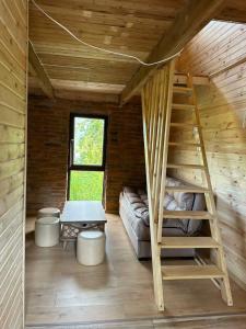 a room with a bunk bed and a ladder in a cabin at კოტეჯი in Ts'ikhisdziri