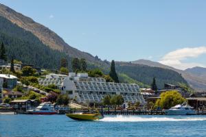 a boat in the water in front of a hotel at Crowne Plaza Queenstown by IHG in Queenstown