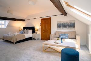 a living room with a bed and a couch at St James House Timeless Comfort Central Congleton in Congleton