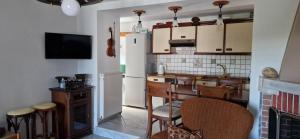 a kitchen with a refrigerator and a table and chairs at Villa Michalis in Theológos