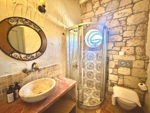 a bathroom with a sink and a mirror and a shower at Dort Mevsim Alacati in Alaçatı +29 photos