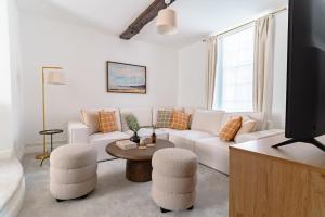 a living room with a white couch and a table at St James House Timeless Comfort Central Congleton in Congleton