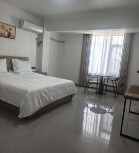 a bedroom with a bed and a table and chairs at #1 Diamond Hotel and Residences in Georgetown