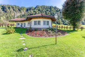 a small house in the middle of a yard at Berghof-Chalet in Erpfendorf