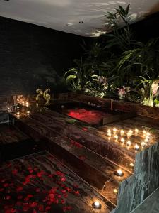 a garden with candles and flowers and lights at Privespa Calma in Tilburg