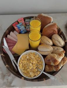 a plate of food with bread and eggs and drinks at Privespa Calma in Tilburg