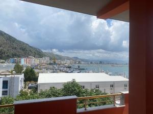 a balcony with a view of a city and the water at Ankor view in Shëngjin +1 photo