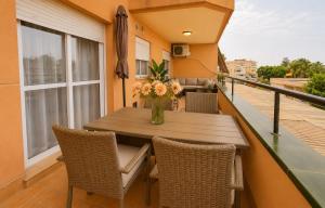 a balcony with a wooden table and chairs at BlueSabinillas in San Luis de Sabinillas