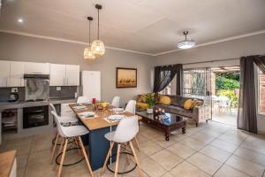 a kitchen and living room with a table and chairs at Dew Drop Inn in Nelspruit +38 photos