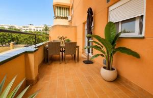 a balcony with a table and chairs and a plant at BlueSabinillas in San Luis de Sabinillas