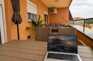 a laptop computer sitting on a table on a balcony at BlueSabinillas in San Luis de Sabinillas +25 photos
