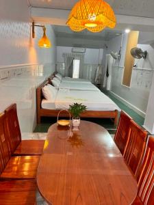a room with a wooden table and a bed at Cát Home in Phú Hiệp +12 photos