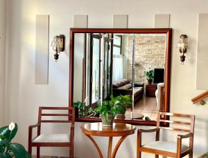 a room with a table and two chairs and a mirror at Hotel Covadonga in Cangas de Onís
