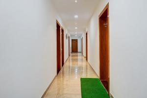a corridor with a green carpet in a building at Collection O Dehu Alandi Road Formerly KP Pride in Dehu