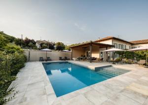 a swimming pool in the backyard of a house at Villa Curte Nicia in Nizza Monferrato