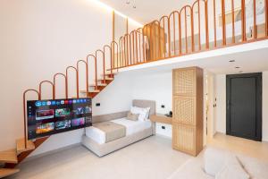 a living room with a bed under a staircase at Maesa Suite in Borsh