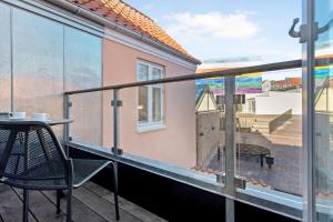 a balcony with a table and a chair and a view at Hotel Varde Garten in Varde