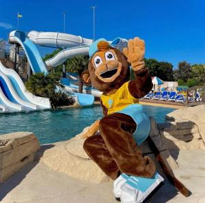 a mascot in front of a water park at Camping les sables in Aytré