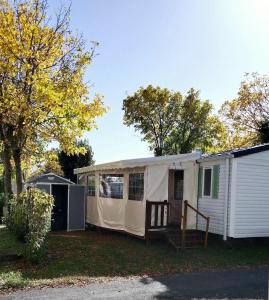 a large white tent sitting next to a house at Camping les sables in Aytré