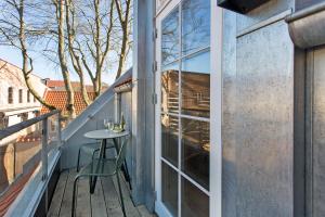 a small table on the balcony of a house at Hotel Varde Garten in Varde