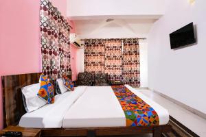 a bedroom with a bed and a tv in it at Triple Beach Guest House in Benaulim