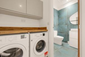 a laundry room with a washing machine and a toilet at Private Double Room in Spacious House with Garden in Blackrod +81 photos
