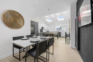 a kitchen and dining room with a table and chairs at Private Double Room in Spacious House with Garden in Blackrod