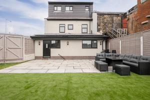 a backyard with a patio and a house at Private Double Room in Spacious House with Garden in Blackrod
