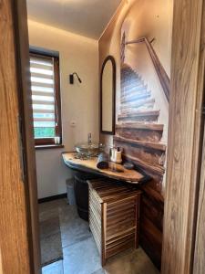 a bathroom with a sink and a counter with a mirror at Dom Na Wsi z Balią Ogrodową-Jacuzzi in Mierzwin Duży